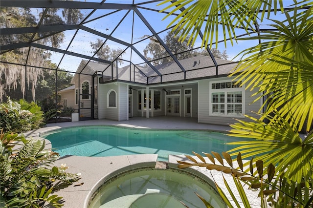 view of swimming pool featuring glass enclosure, a ceiling fan, french doors, and a patio
