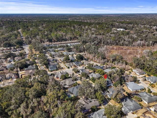 birds eye view of property with a residential view and a wooded view