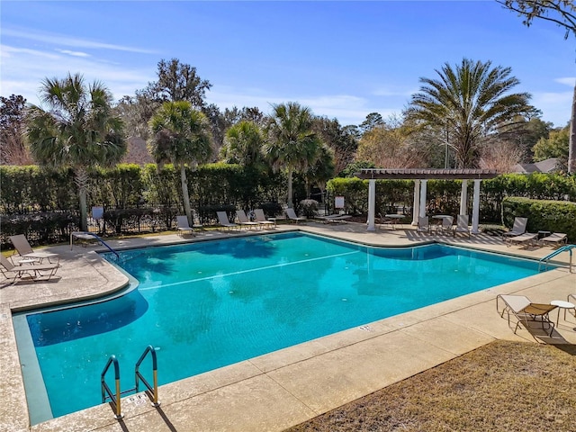 pool featuring a pergola, a patio area, and fence