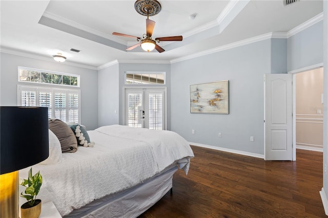 bedroom with dark wood-style floors, a tray ceiling, visible vents, access to exterior, and baseboards