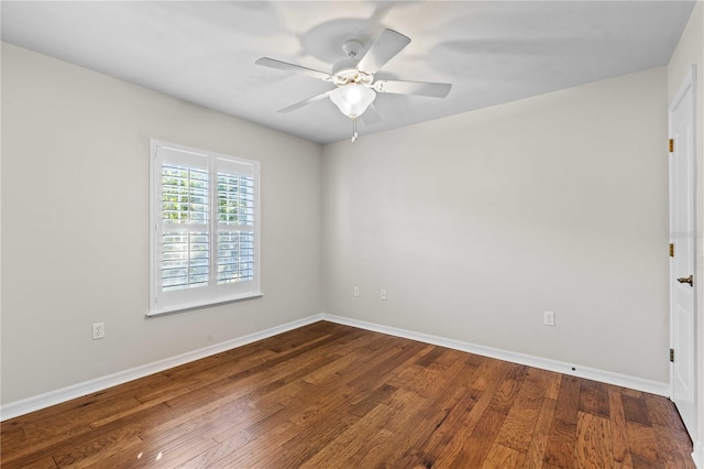 unfurnished room featuring baseboards, wood finished floors, and ceiling fan