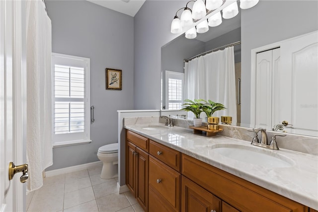 bathroom featuring a healthy amount of sunlight, a sink, and toilet