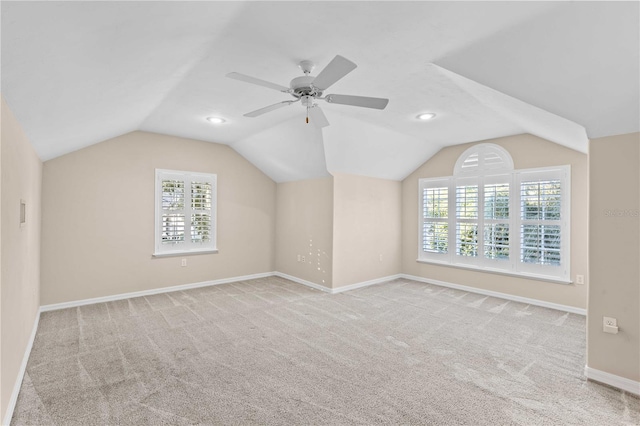 additional living space featuring vaulted ceiling, carpet flooring, and a wealth of natural light