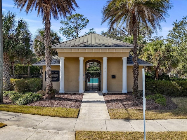 view of front of house with a gate, fence private yard, and stucco siding