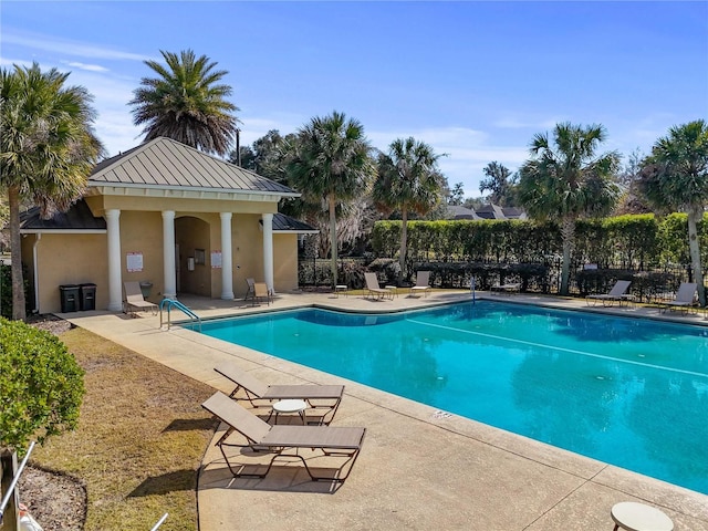 pool with fence and a patio area
