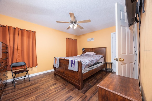 bedroom with a textured ceiling, ceiling fan, a wall unit AC, and dark hardwood / wood-style floors