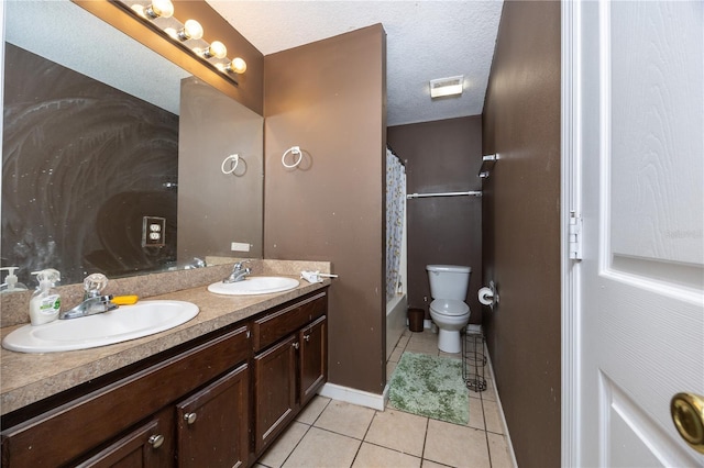 full bathroom featuring shower / bath combo, tile patterned floors, vanity, a textured ceiling, and toilet