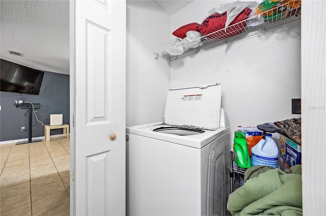 laundry room with washer / clothes dryer, tile patterned flooring, and a textured ceiling