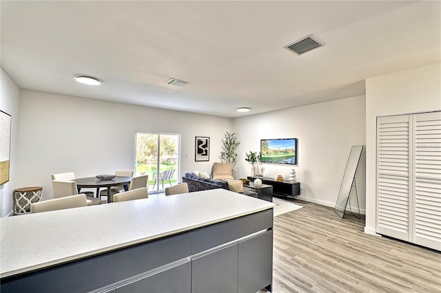 kitchen with gray cabinets and light hardwood / wood-style flooring