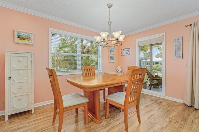 dining area featuring a notable chandelier, ornamental molding, and light hardwood / wood-style flooring