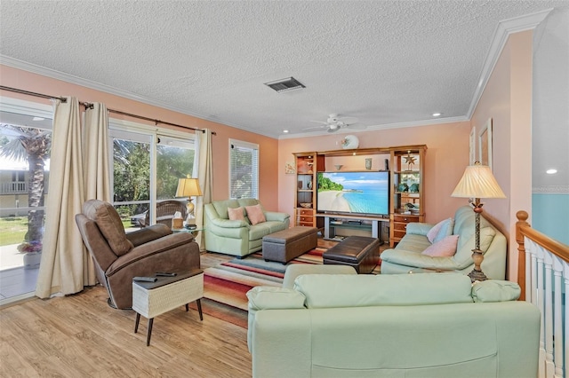 living room with a textured ceiling, ceiling fan, crown molding, and light hardwood / wood-style flooring