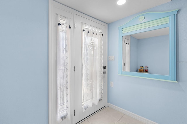 entryway featuring light tile patterned floors and a healthy amount of sunlight