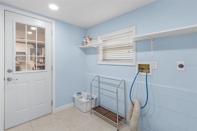 laundry area featuring hookup for an electric dryer, light tile patterned flooring, and hookup for a washing machine