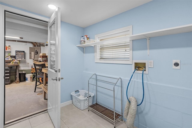 laundry area featuring electric panel, hookup for a washing machine, light tile patterned flooring, and hookup for an electric dryer