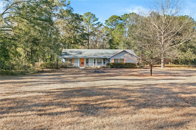 view of front of house with covered porch and a front yard