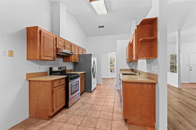 kitchen featuring plenty of natural light, sink, light tile patterned floors, and stainless steel appliances