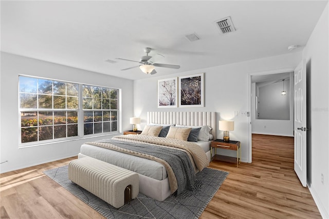 bedroom featuring ceiling fan and light hardwood / wood-style flooring