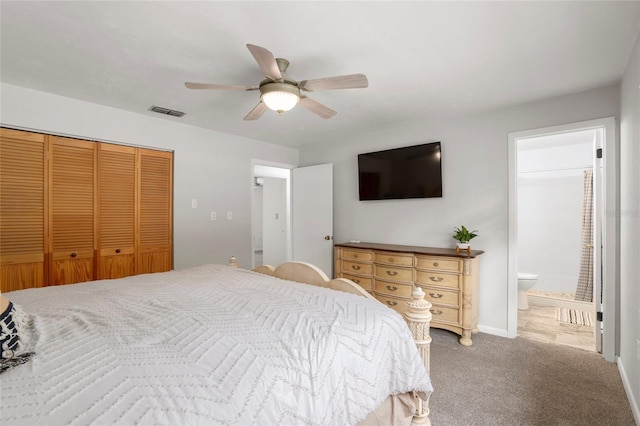 bedroom with ensuite bathroom, a closet, carpet, and ceiling fan