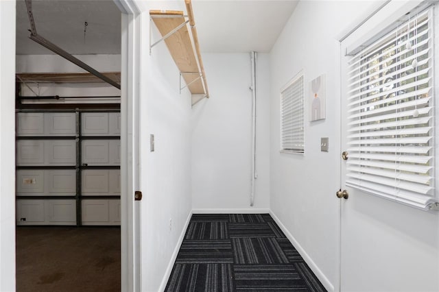 spacious closet featuring dark colored carpet