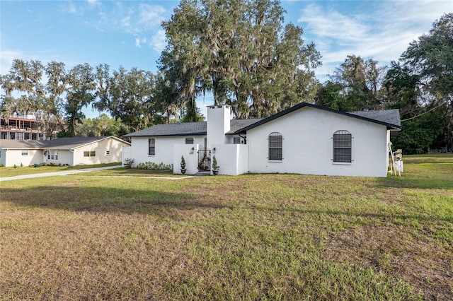 rear view of property featuring a yard