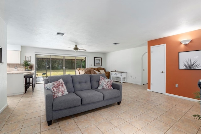 living room with ceiling fan and light tile patterned floors