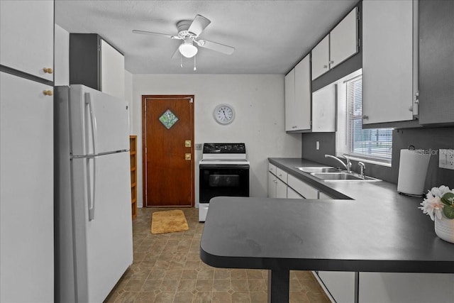 kitchen featuring a textured ceiling, white appliances, ceiling fan, sink, and white cabinets