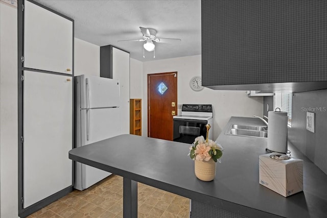 kitchen featuring a textured ceiling, white appliances, ceiling fan, sink, and white cabinets