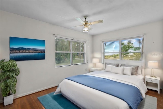 bedroom with ceiling fan and dark hardwood / wood-style flooring