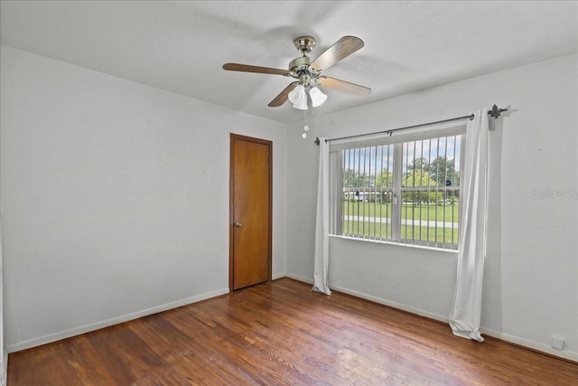 spare room featuring hardwood / wood-style floors and ceiling fan