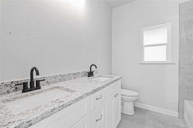 bathroom with tile patterned floors, vanity, and toilet