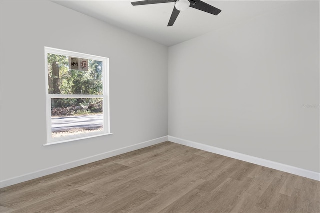 empty room featuring ceiling fan and light hardwood / wood-style flooring