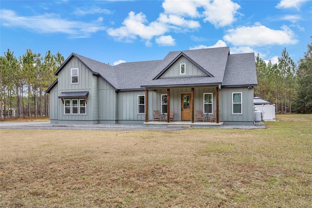 view of front of home with covered porch and a front yard