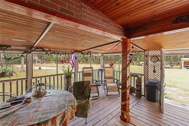 wooden terrace with a yard