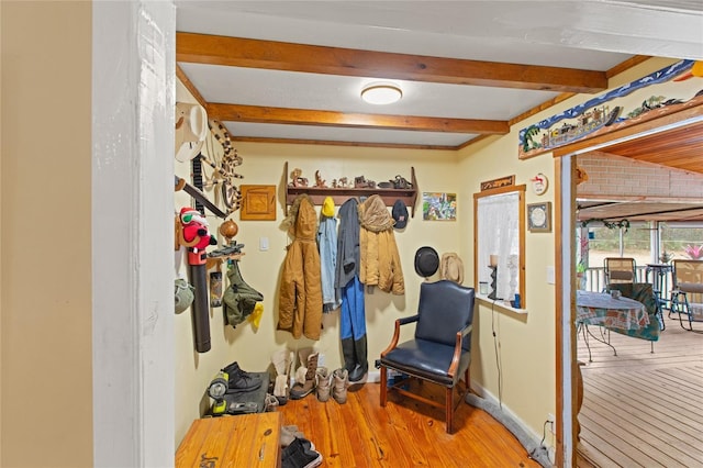 interior space with beamed ceiling and light hardwood / wood-style flooring