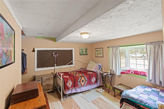 bedroom featuring hardwood / wood-style floors and a textured ceiling