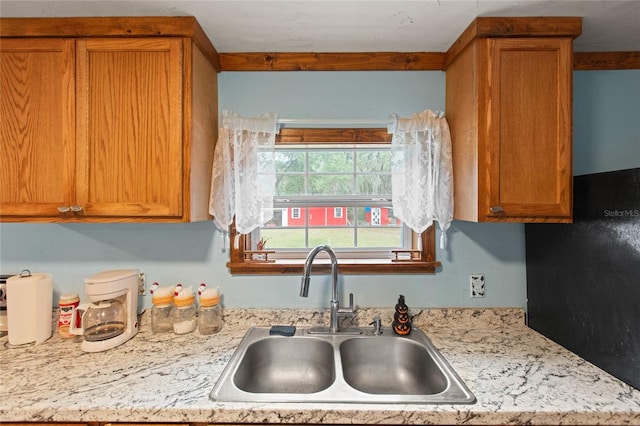 kitchen with sink and light stone counters