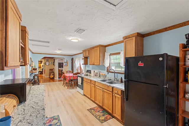 kitchen with sink, light hardwood / wood-style flooring, electric range, ornamental molding, and black fridge