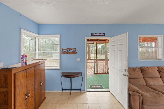 doorway to outside with light tile patterned flooring