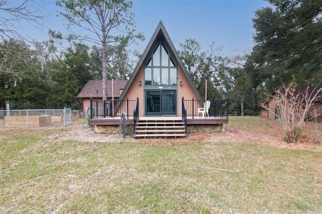 rear view of house with a yard and a wooden deck