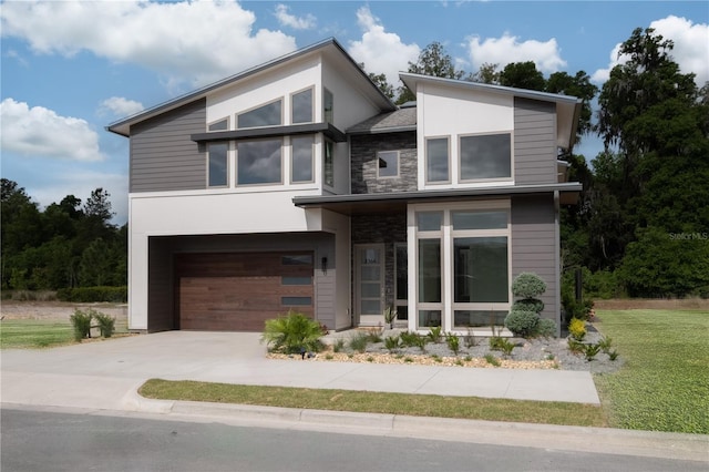 contemporary home with a garage and a front lawn