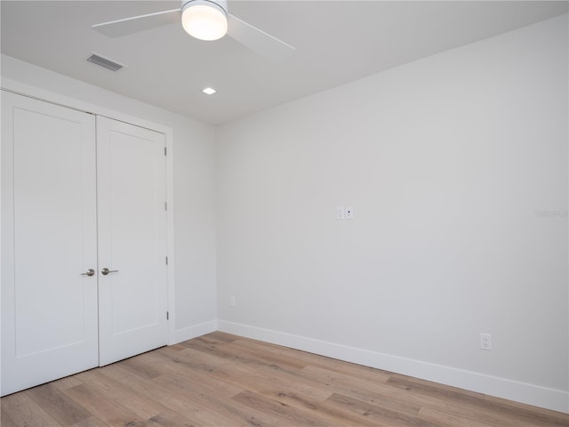 unfurnished bedroom with a closet, light hardwood / wood-style flooring, and ceiling fan