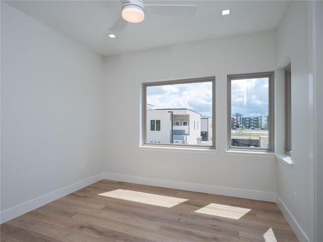 spare room featuring ceiling fan and light wood-type flooring