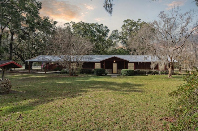 ranch-style house featuring a yard and a carport