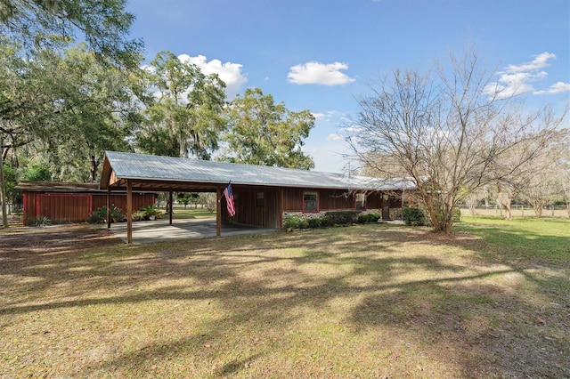 view of front of home with a front yard and a carport