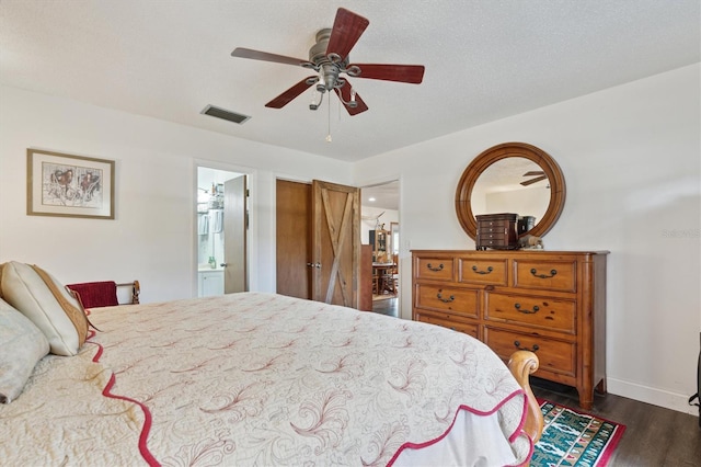 bedroom with connected bathroom, dark hardwood / wood-style floors, and ceiling fan