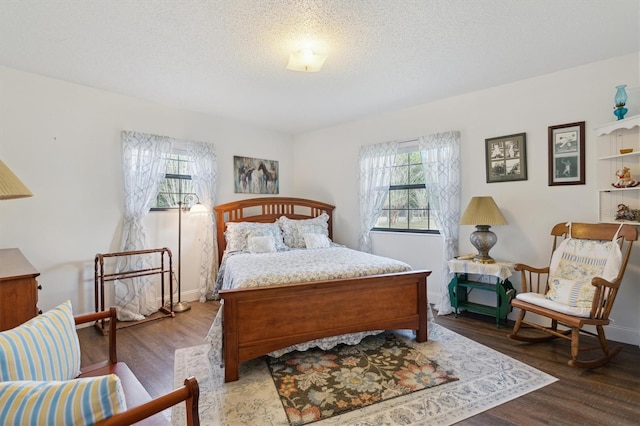 bedroom with wood-type flooring and a textured ceiling