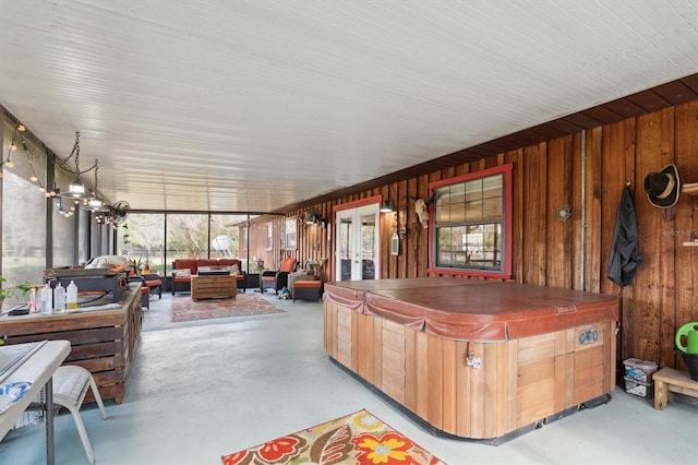 sunroom / solarium featuring french doors and a hot tub