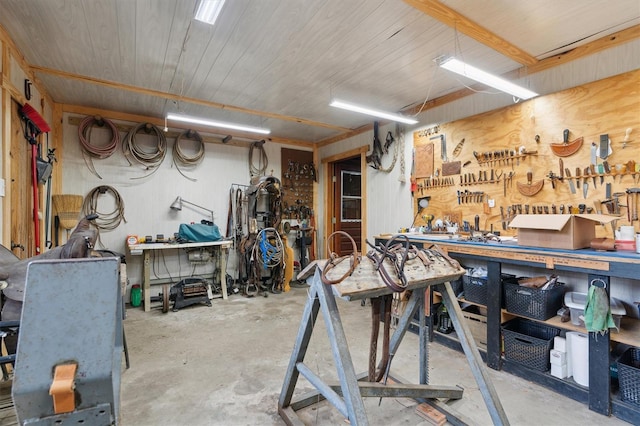 misc room with a workshop area and concrete flooring