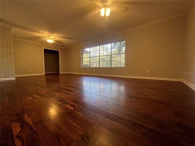 empty room with ceiling fan, dark hardwood / wood-style flooring, and crown molding