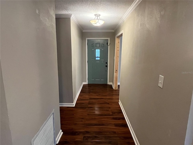 hall featuring a textured ceiling, crown molding, and dark wood-type flooring